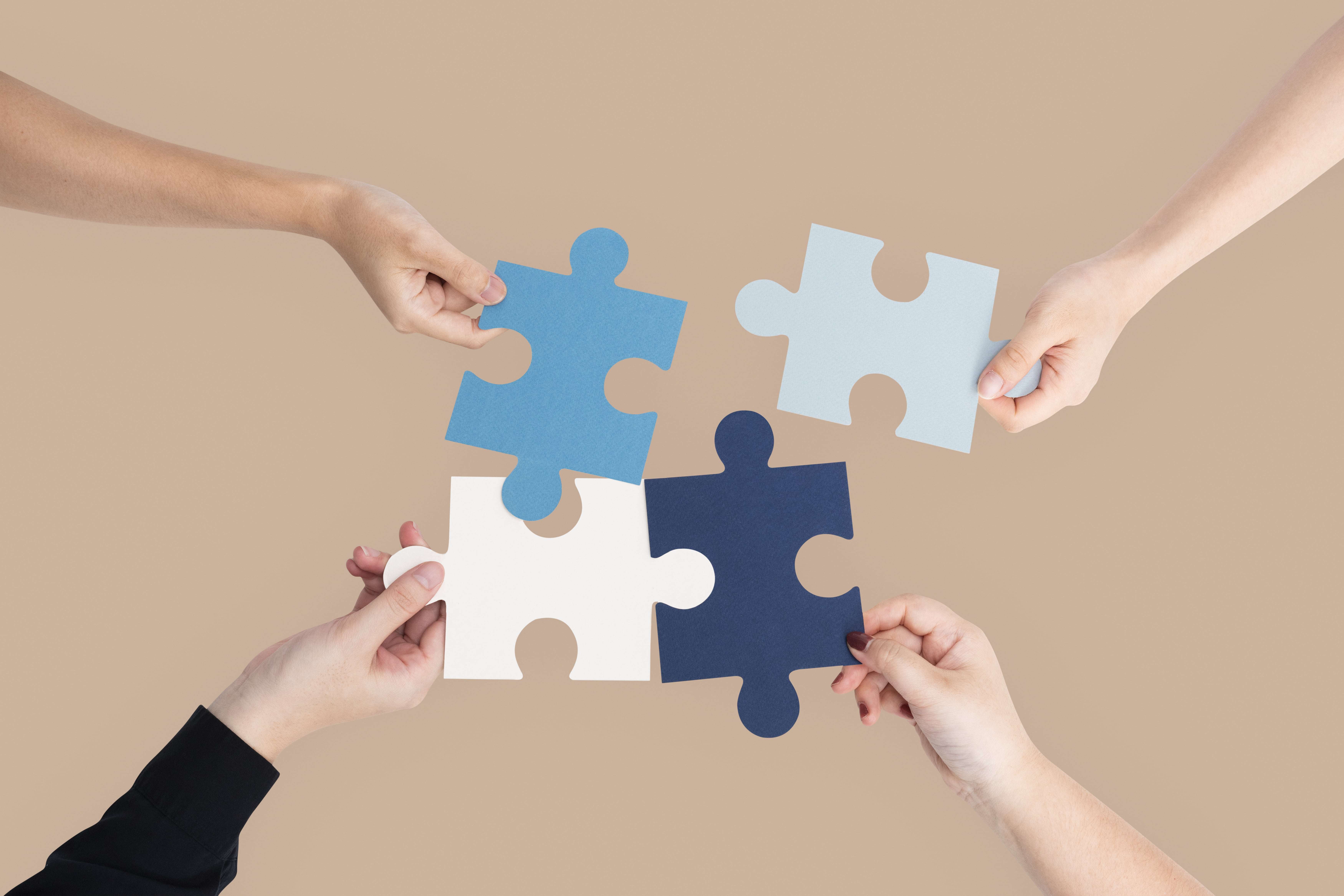 hands-holding-puzzle-business-problem-solving-concept-min